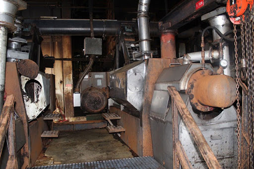 View of a fat press in a rendering plant that has been damaged by fire.