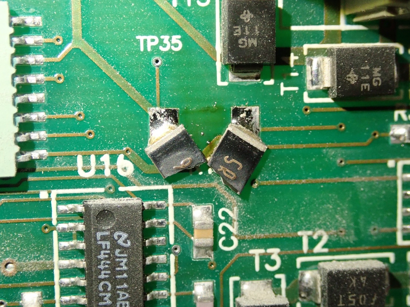 Damaged electronic component on alarm system circuit board