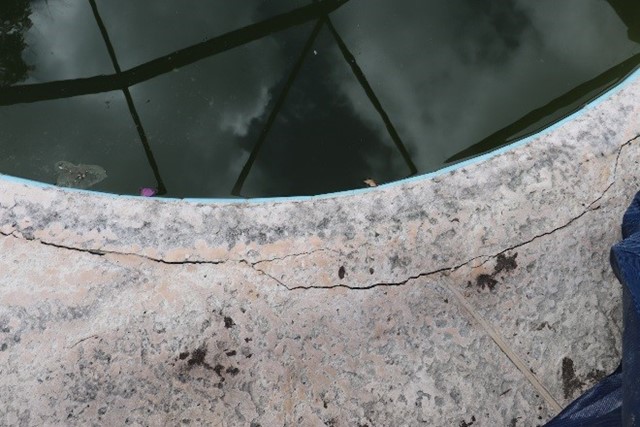 Cracks in concrete around pool's edge