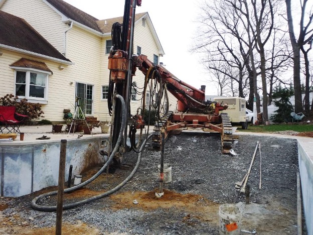Image of foundation repair– using a rig to install pipe casing 