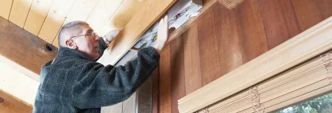 Man Adjusting Fluorescent Bulb