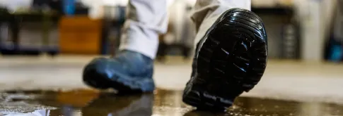 Photo of boots walking through puddle of water